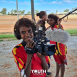 aboriginal children using film equipment